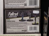 two boxes of miniature military figures on display in a store