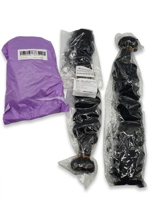 two bundles of black hair wrapped in plastic bags on a white surface