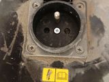 a black electrical outlet with a yellow tag on it