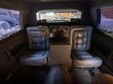 two seats in the back of a bus that are empty