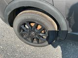 a black car with a flat tire on the street