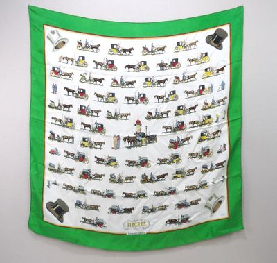 an image of a green scarf with a picture of horses and carriages on it