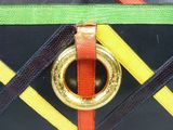a black purse with a gold ring on it