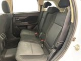 the back seats of a white car with black trims
