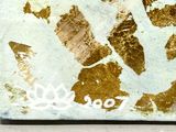 a painting of a peace sign made out of gold paint