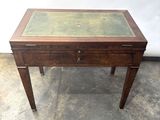 a small wooden table with a glass top on it