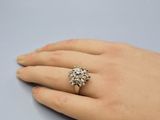 a close up of a person ' s hand with a ring on it