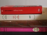 several books are stacked on top of each other on a table