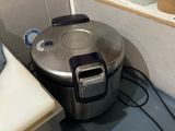 a small kitchen with a stove, sink, and toaster on the counter