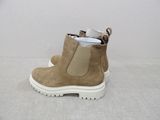 beige leather boots with white soles on a white surface
