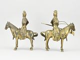 pair of antique brass figurines of a man on a horse and a woman on a horse