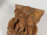 an image of a wooden sculpture of a ship with a man and a woman on it
