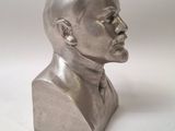 silver metal bust of a man on a white background