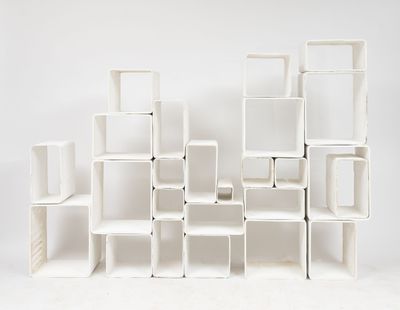 a white shelf that has a lot of cubes on it