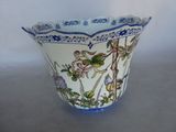 a blue and white vase with flowers and birds on it
