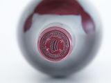 a close up of a wine bottle with a red label