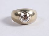 a close up of a gold ring with a diamond in the center