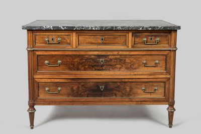 an antique chest of drawers with marble top