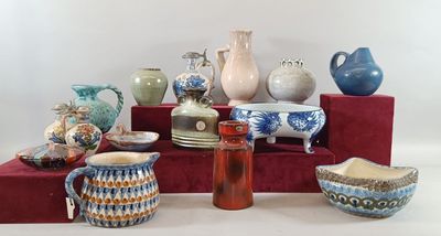 many different vases and bowls on display on a table
