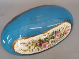 a blue plate with flowers on it sitting on a table