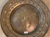 a silver plate on the table with a tag on it
