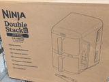 packaging of a coffee maker sitting on top of a box on a table