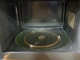 a microwave that has a green plate inside of it