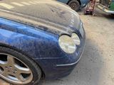 a blue car that is parked on the side of the street