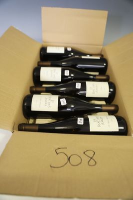several bottles of wine are in a cardboard box on a table