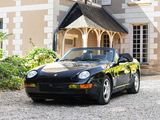 a black sports car parked in front of a large house