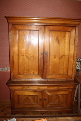 a wooden cabinet with a book on top of it