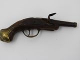 an old gun that is sitting on a white surface