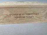 a wooden box with four bottles of wine in it