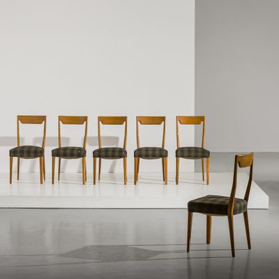 six chairs in a room with a white floor and a white wall