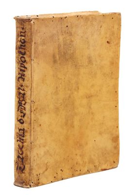 an old book with writing on it sitting on a white surface