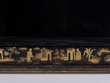 an image of a black and gold painted cabinet with a black background
