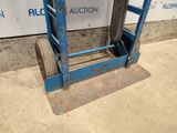 an image of a blue hand truck sitting on the ground