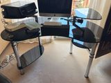 a computer desk with a monitor and keyboard on it