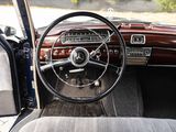 steering wheel and dashboard of a classic car in a parking lot