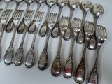a lot of silver spoons and forks on the table
