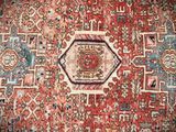 an antique persian rug with a medallion design on a red ground
