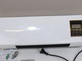 an air conditioner sitting on top of a counter next to a remote control