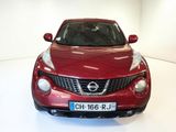 a red nissan juke parked in a white room