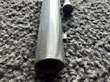 a close up of a metal pipe on a carpeted floor