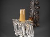 pair of crystal wall sconces in the shape of a candle holder