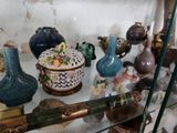 une vitrine en verre sur laquelle sont disposés de nombreux vases de styles variés