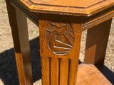 a small wooden table with a carved design on it
