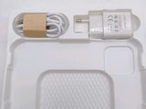 a white box with a charger and a cord attached to it