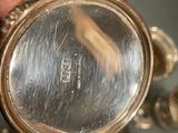 a close up of a person ' s hand holding a watch