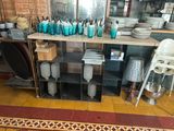 many dishes and cups on the table in the kitchen